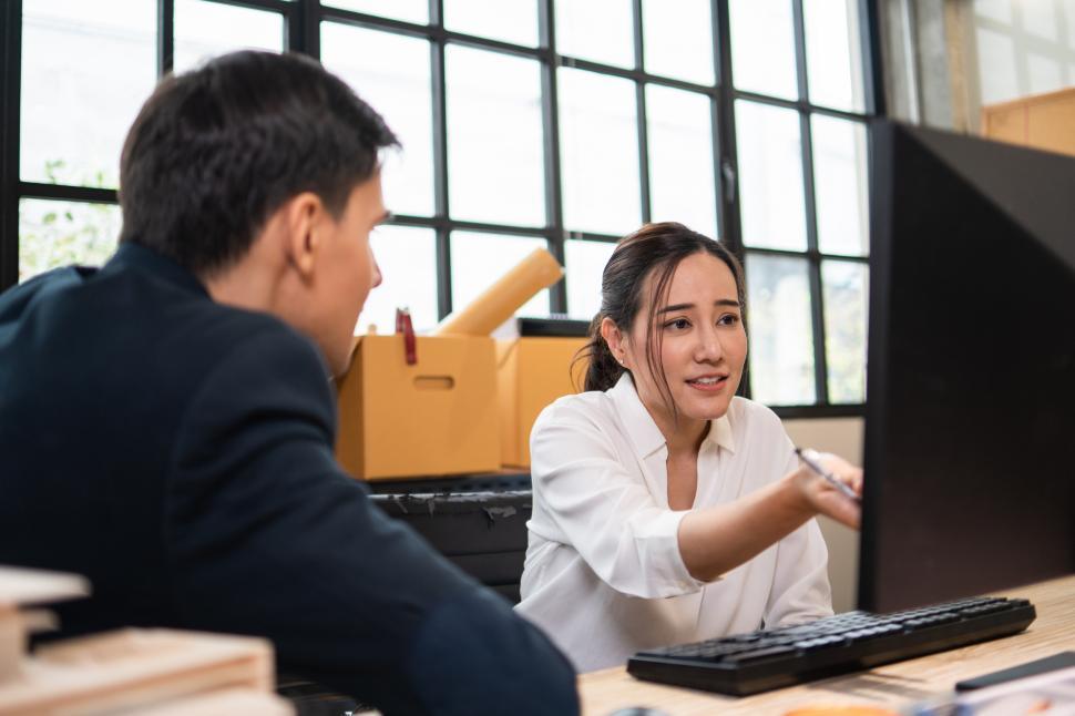 Free Image of Female employee sitting and presenting project on computer 