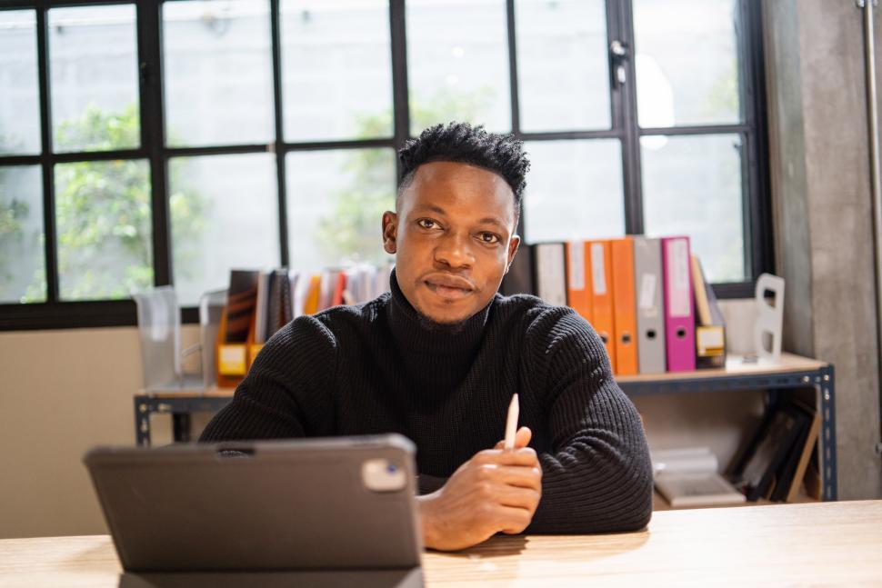 Free Image of Portrait of creative man working with digital tablet 