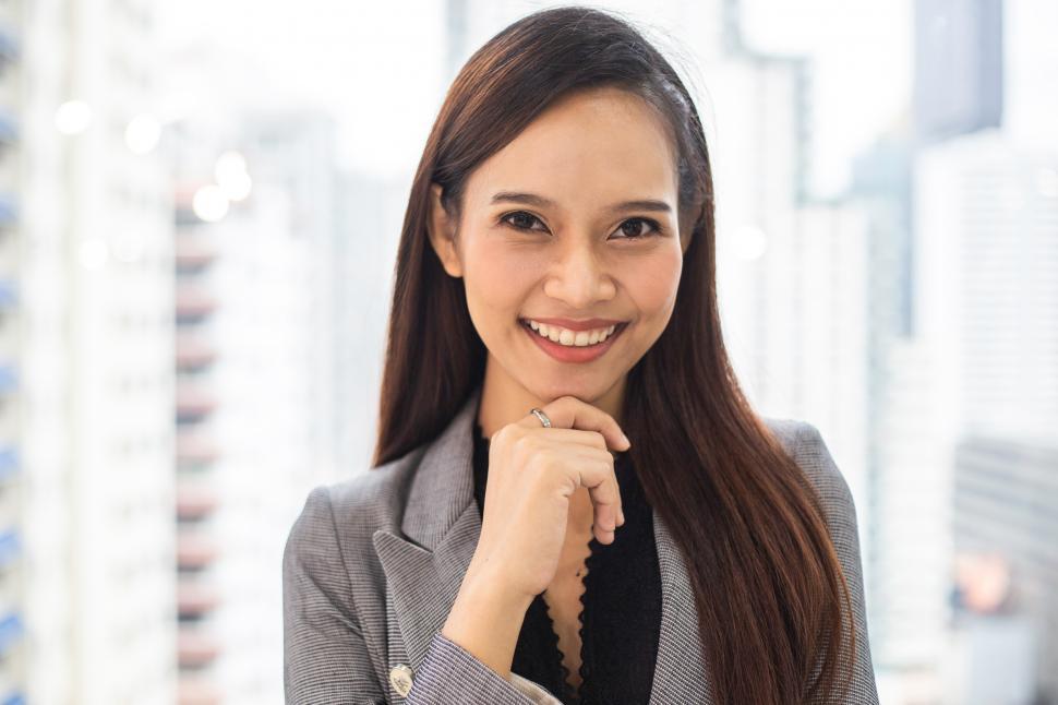 Free Image of Portrait of smiling businesswoman standing in the office 