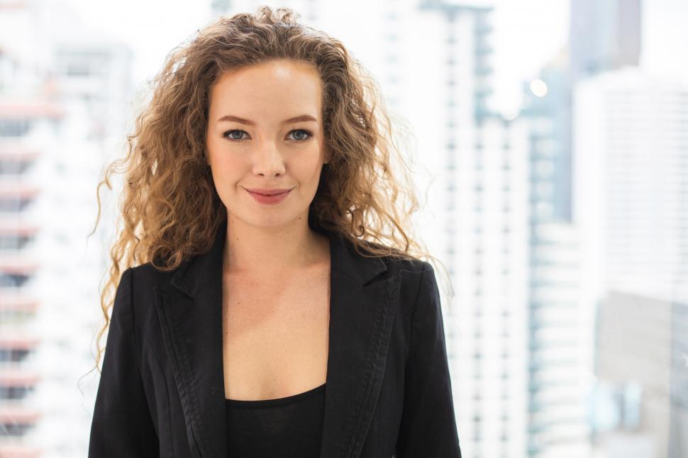 Free Image of Portrait of businesswoman standing in the office, looking at camera 