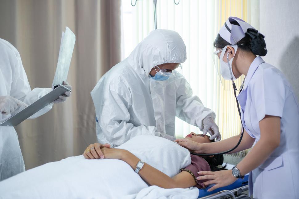 Free Image of Emergency paramedic doctor in PPE suit performing first aid 