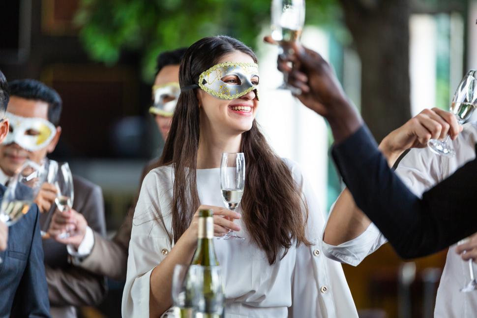 Free Image of Happy group of office worker in fancy masks enjoy a drink 