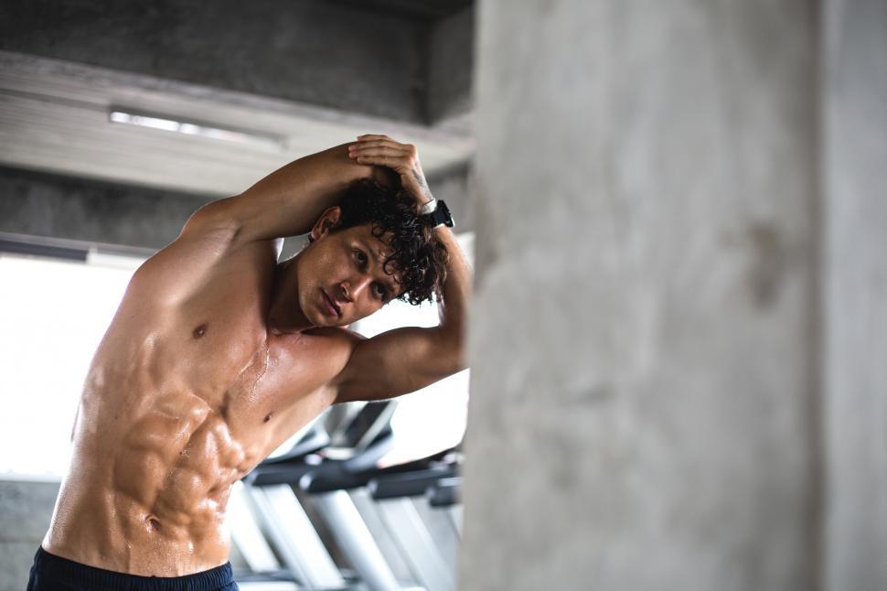 Free Image of Muscular athletic man warms up before workout 