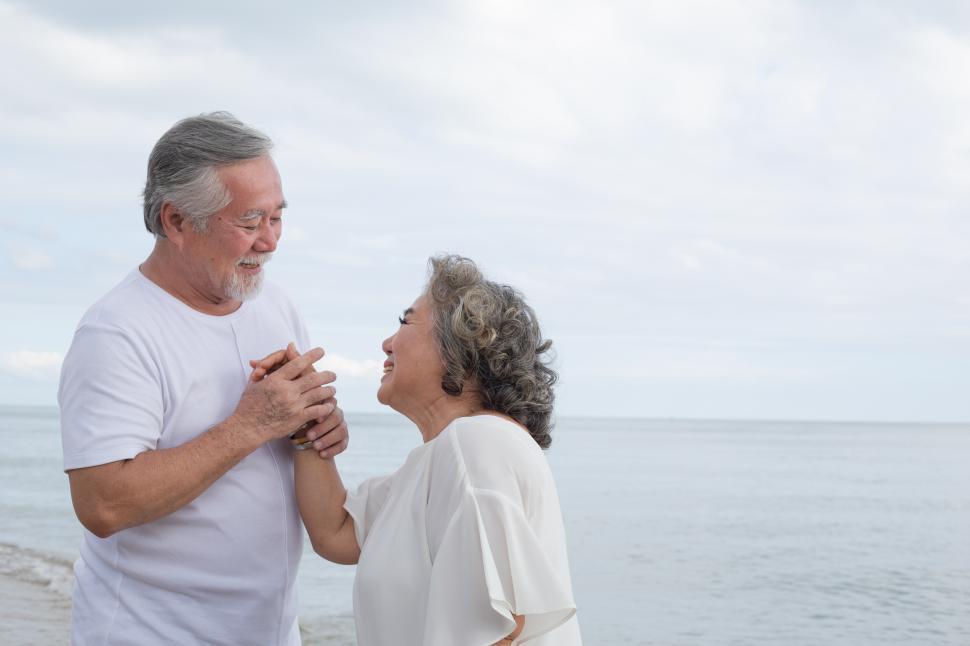 Free Image of Senior couple holding hands at the beach 