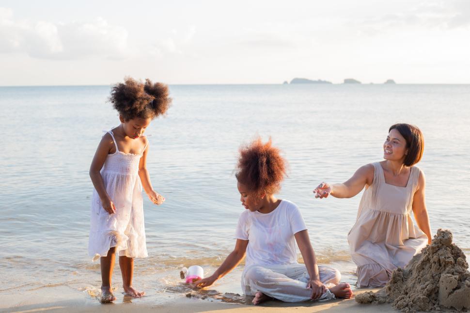 Free Image of Family playing and building sand castles at the beach 
