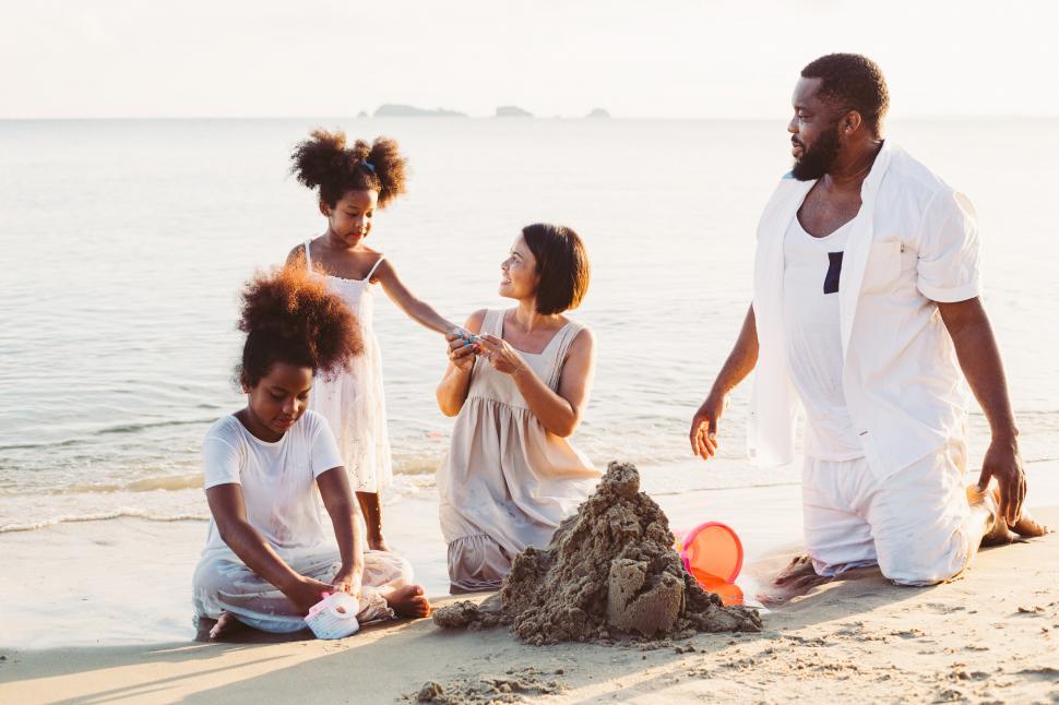 Free Image of Family playing in sand at the beach 