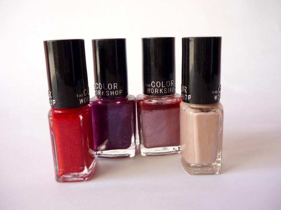 Free Image of Three Bottles of Nail Polish Arranged Together 