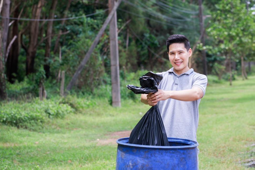 Free Image of Volunteers helping to pick up garbage in side of the road 