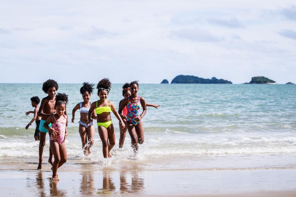 Free Image of Kids group in swimwear playing in the surf 