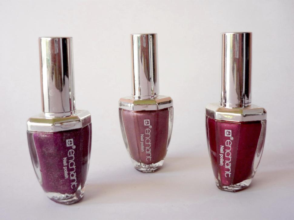 Free Image of Three Bottles of Nail Polish Arranged Together 