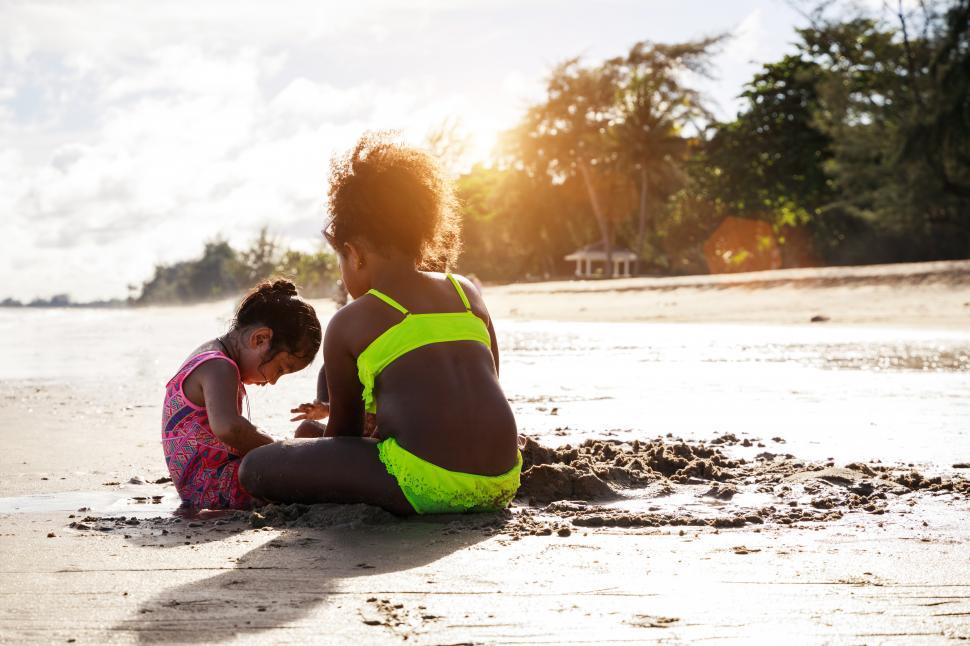 Free Image of KIds playing in sand at the beach 