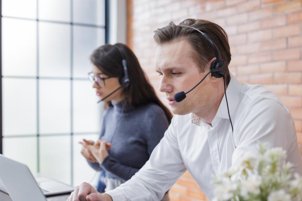 Free Image of women and man answering phone calls 
