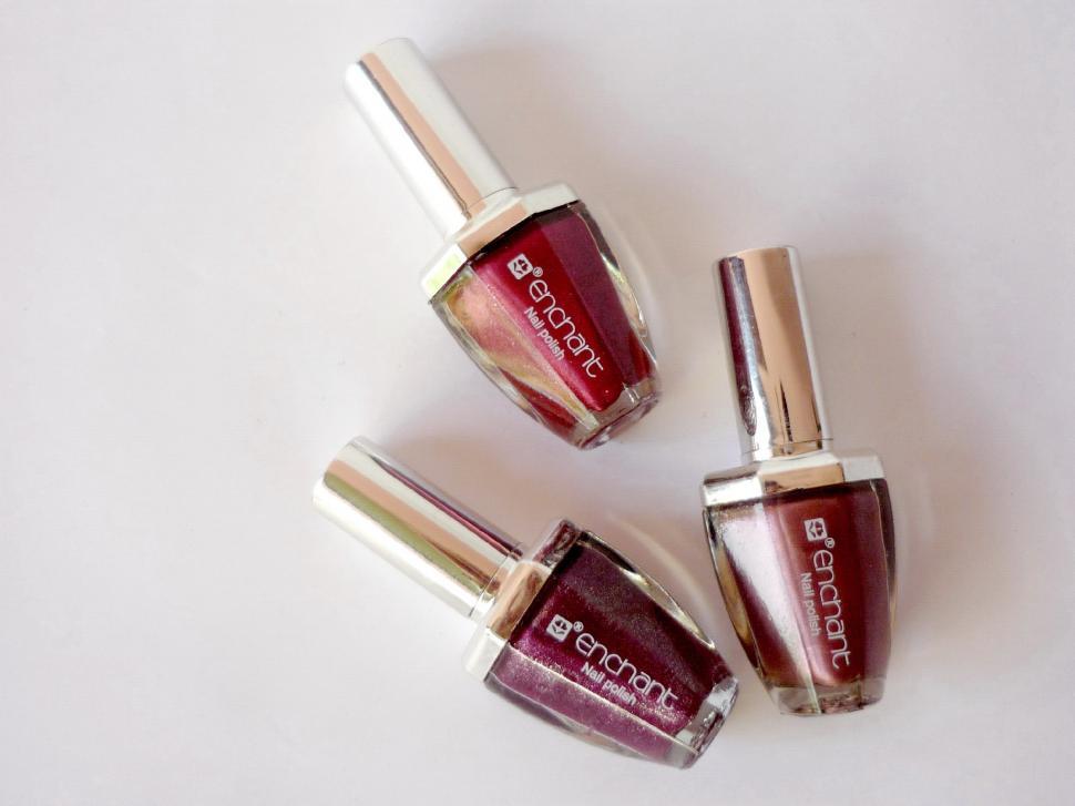 Free Image of Three Bottles of Nail Polish Arranged Together 