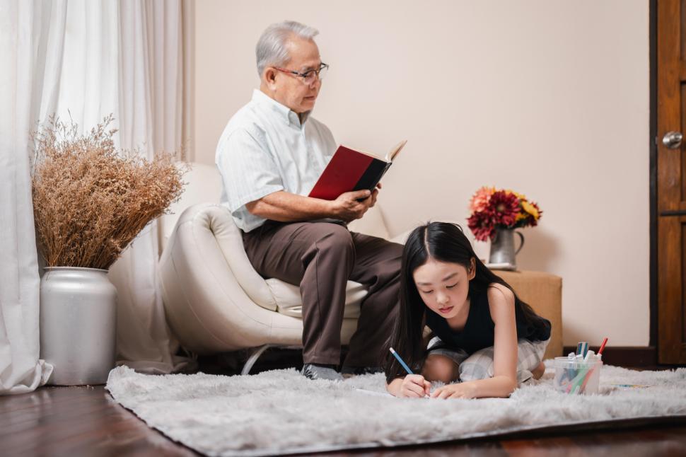Free Image of Granddaughter doing homework with older relative 