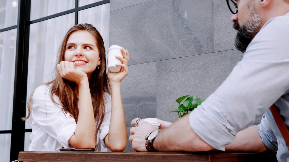 Free Image of Woman Sitting at Table Next to Man 