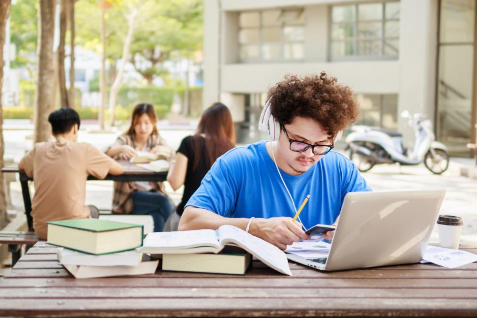 Free Image of College student reading book for exam 