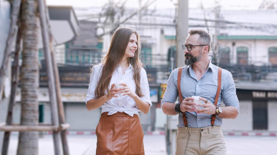 Free Image of Happy man and woman enjoying coffee while walking 
