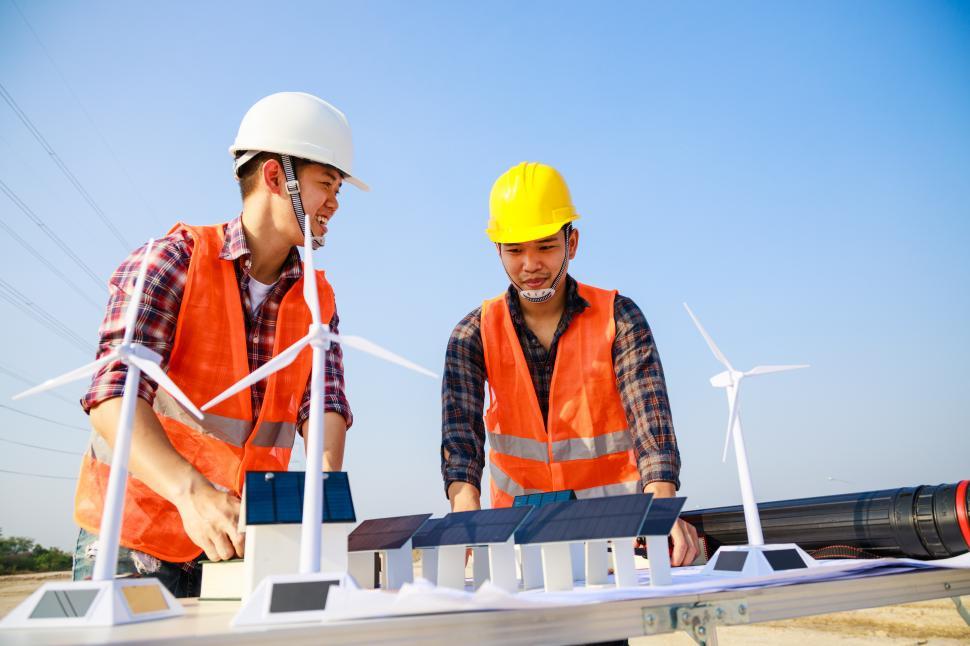 Free Image of Workers discuss wind energy installation 