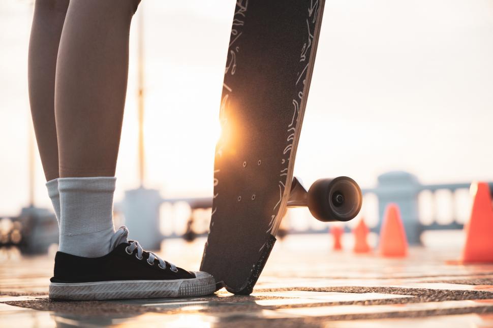 Free Image of Person standing with skateboard, close up 