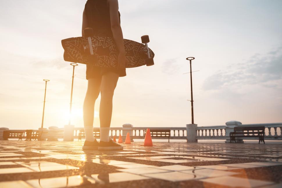 Free Image of Woman holding skateboard in outdoor park 