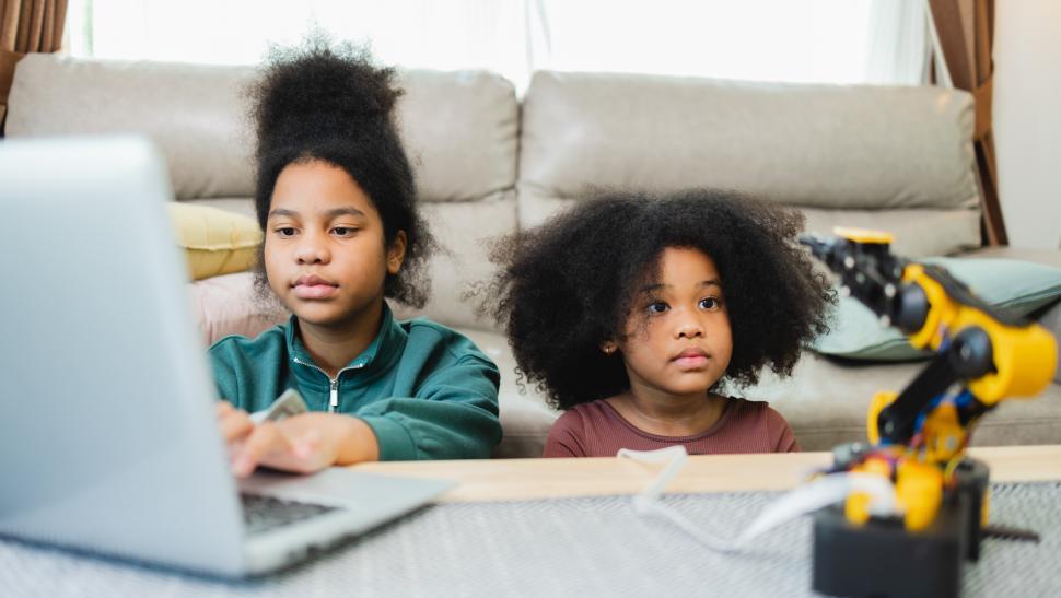 Free Image of Big sister and little sister experiment with robotic arm 