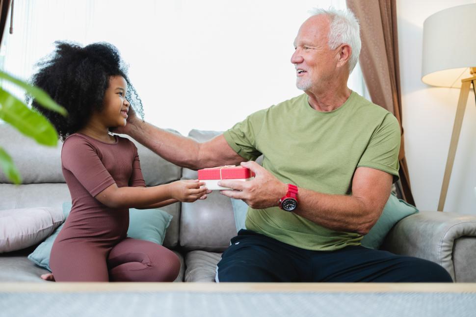 Free Image of Young girl gives gift to older family member 