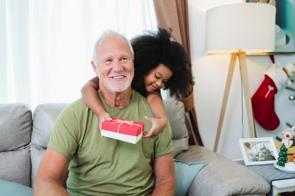 Free Image of Young girl is excited to share gift with family 