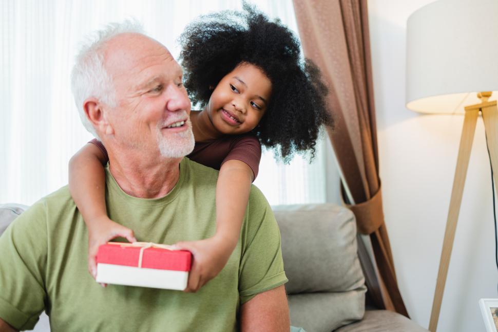 Free Image of Young girls holding gift for older family member 