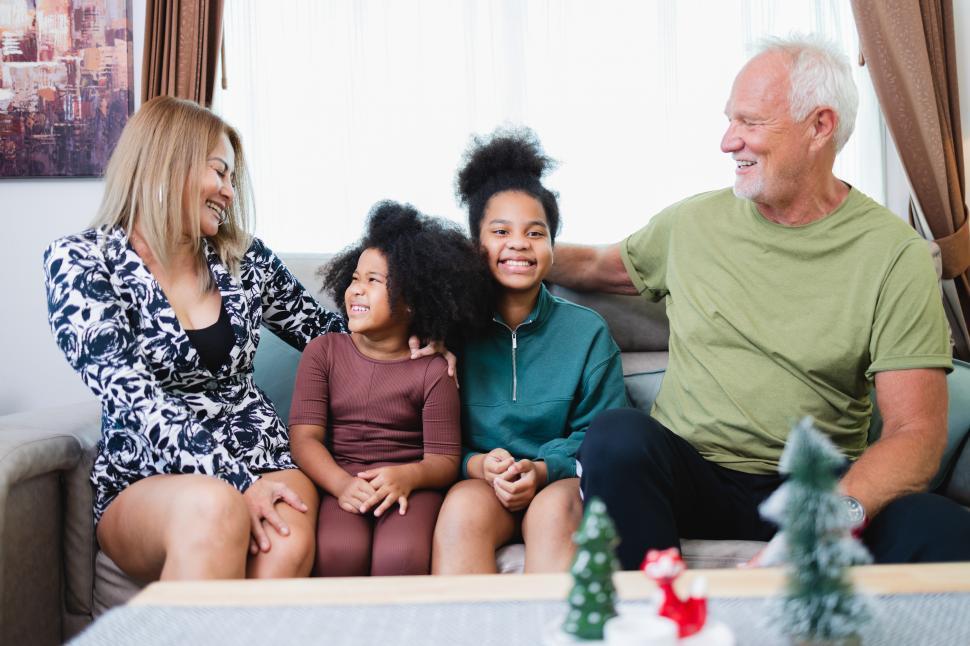 Free Image of Family laughing together in the living room 