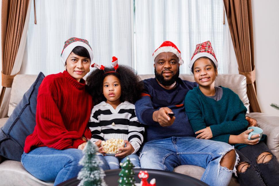 Free Image of Family watching something, sitting together on the couch 