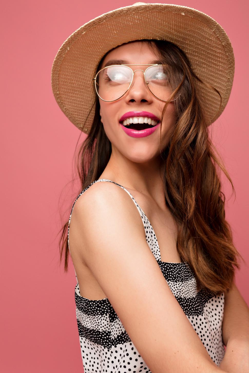 Free Image of Inspired female model looking aside with happy smile 
