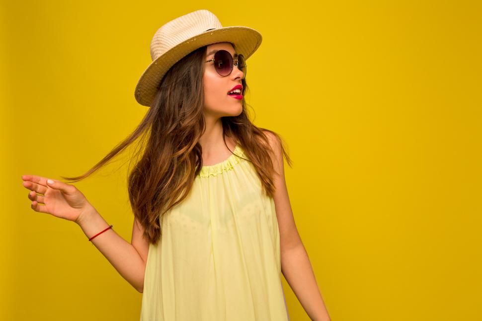 Free Image of Studio shot of young pretty girl with wavy hair dressed for summer 