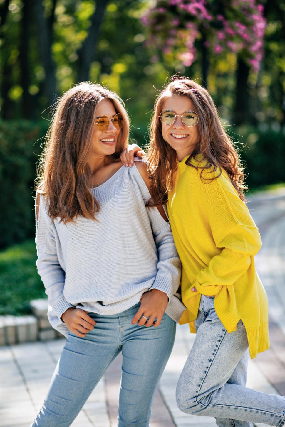 Free Image of Friendly happy girls with  posing in bright sunlight 