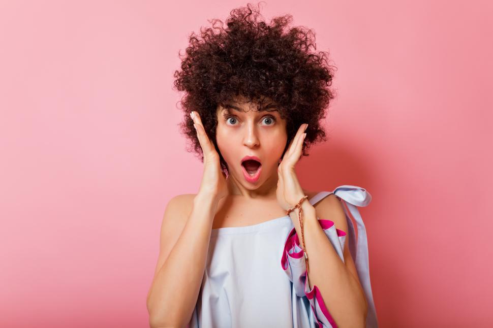 Free Image of Portrait of adorable expressive girl with wavy short hair 