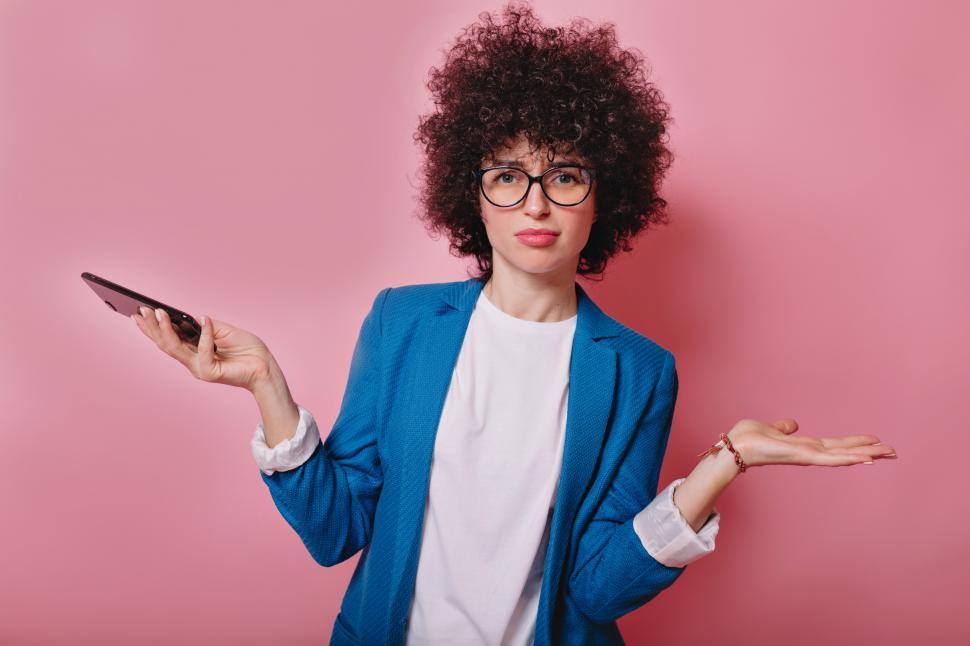 Free Image of Funny attractive young woman makes funny faces poses with phone 