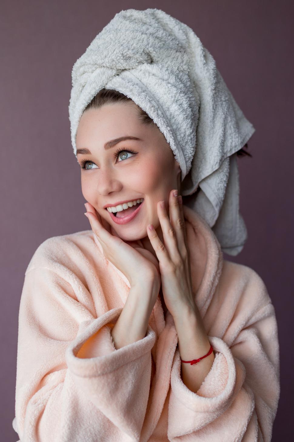 Free Image of Smiling young woman wearing bathrobe and towel 