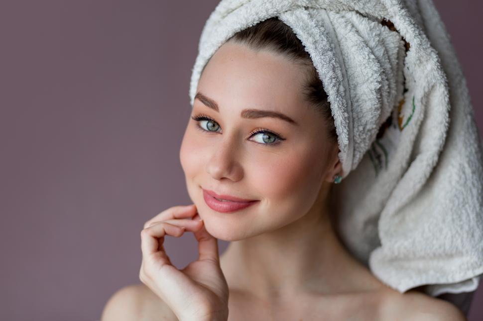 Free Image of Young woman wearing bathrobe and towel over her head 