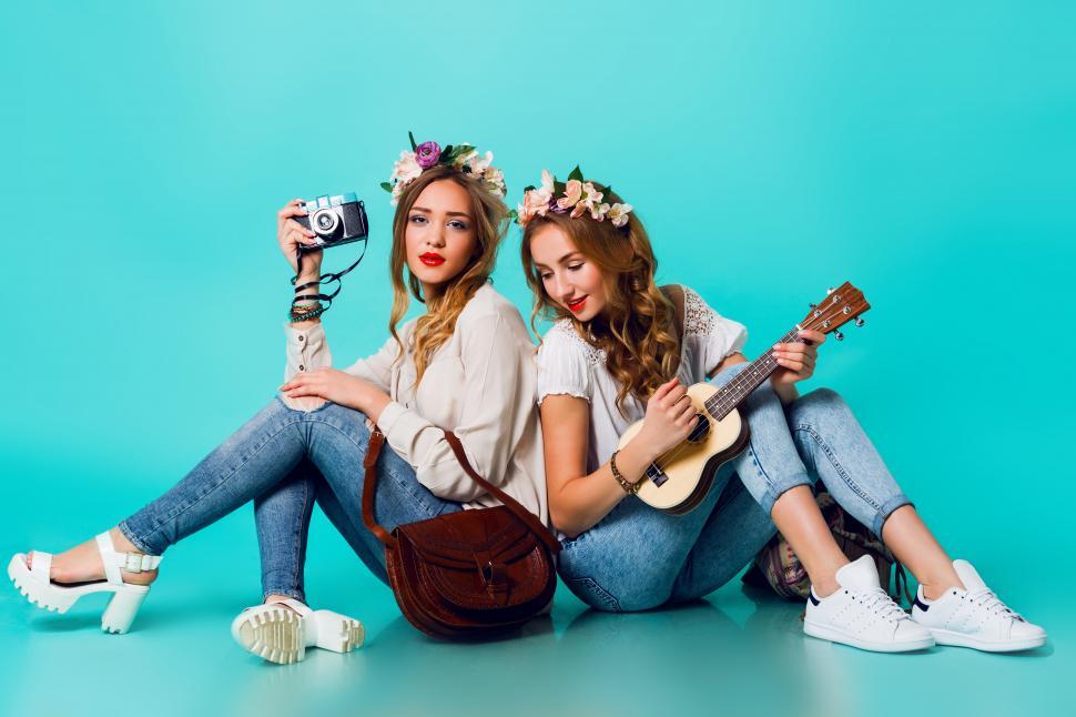 Free Image of Lifestyle portrait of two pretty young blonde happy girls having fun. 
