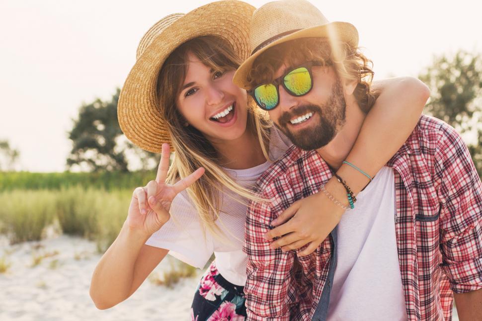 Free Image of Couple or best friends man and woman having fun on summer sunny beach 
