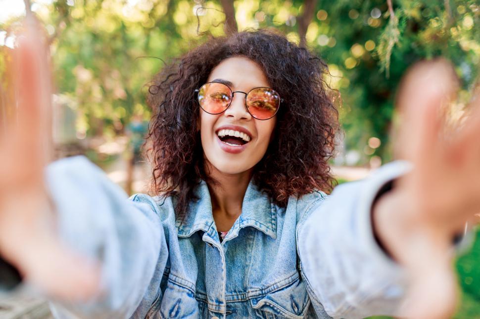 Free Image of Portrait of smiling  black woman in pink glasses 