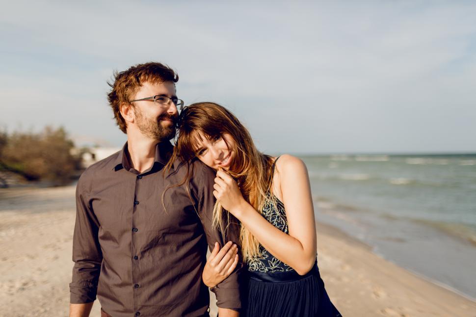 Free Image of Couple in love walking on sunny beach 