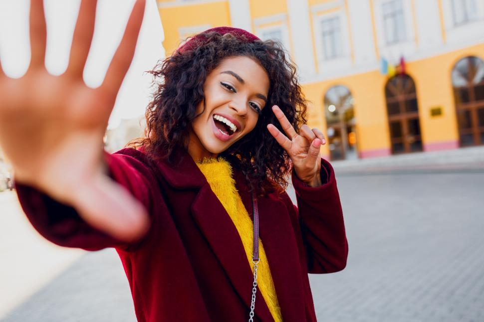 Free Image of Joyful woman with wavy hair making self portrait 