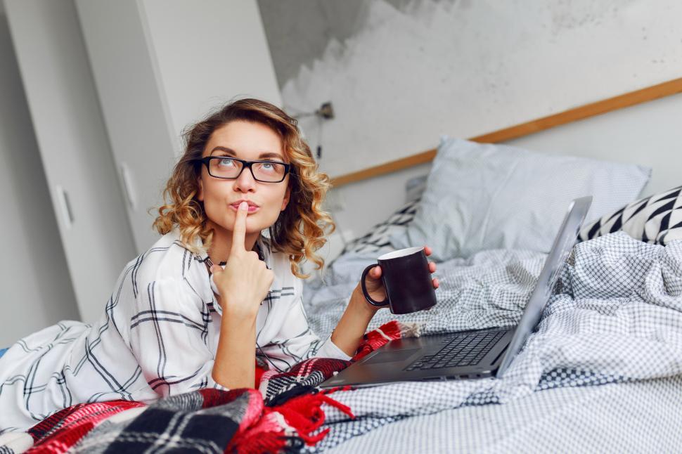 Free Image of Cheerful woman enjoying early morning, gnawing cookies and drinking coffee 