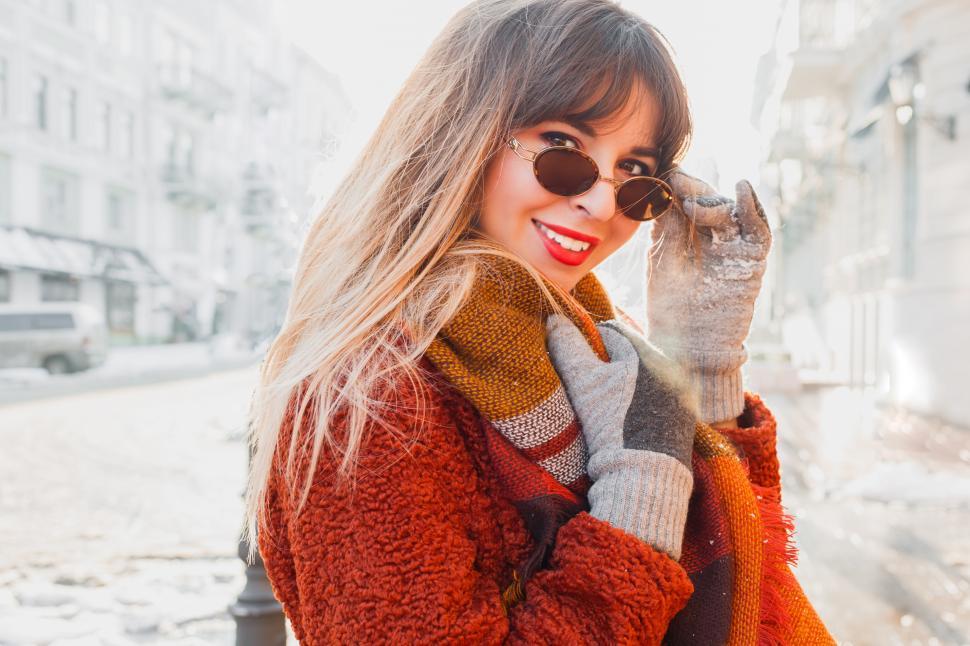 Free Image of Woman with candid smile walking  on old European city 