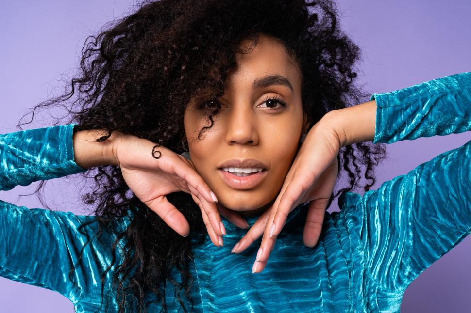 Free Image of Portrait of woman with hands on face 