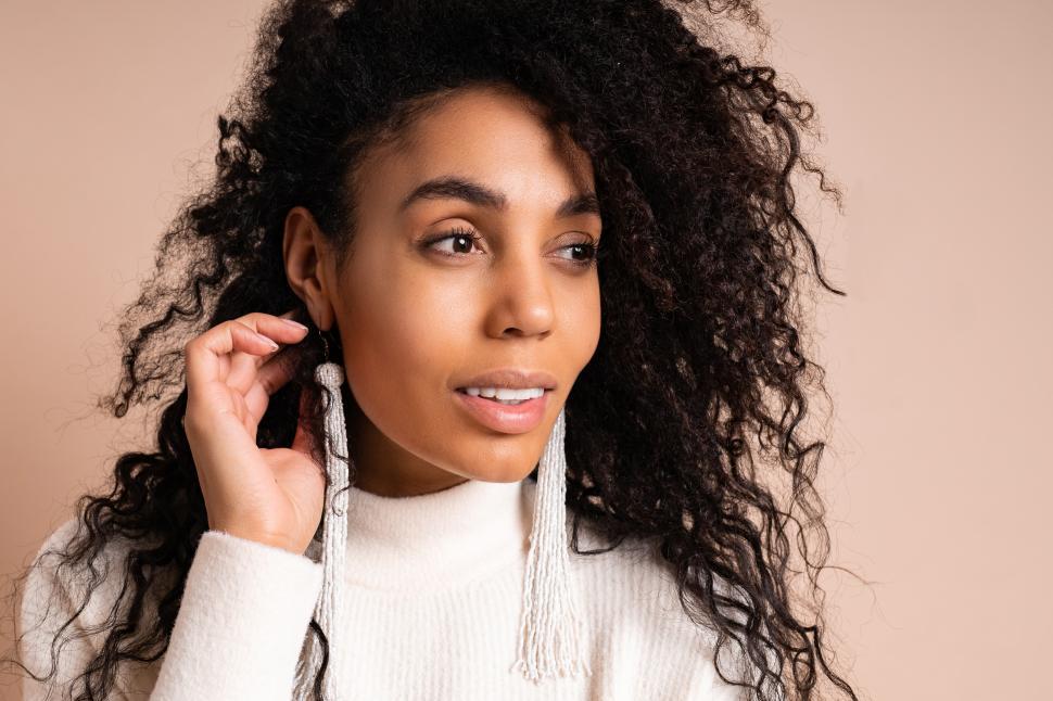 Free Image of Woman wearing stylish earrings and knitted sweater 