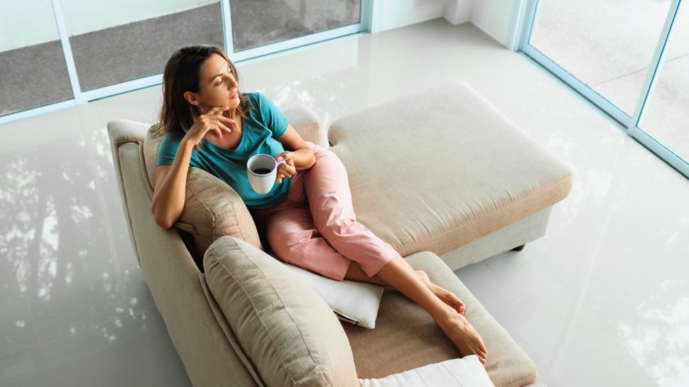 Free Image of Woman in cozy home wear holding cup of tea 