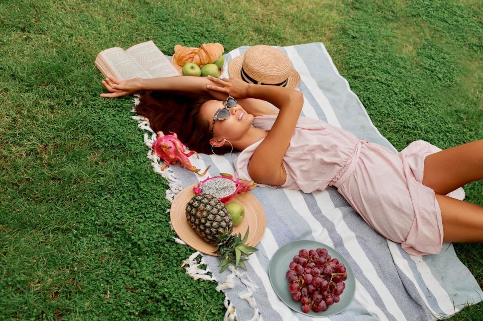 Free Image of Romantic woman in dress lying on green grass 