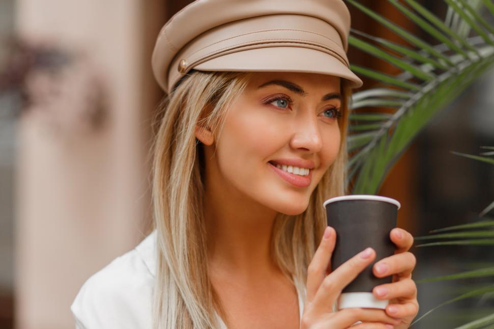 Free Image of Woman enjoying hot coffee outdoors 