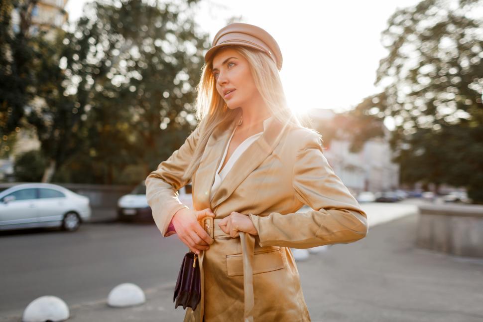 Free Image of Stylish blond woman in beige cap and jacket 